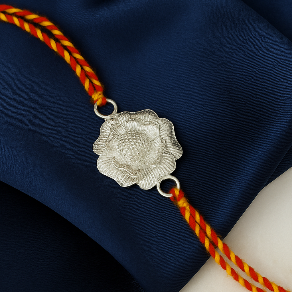 Silver floral pendant on a red