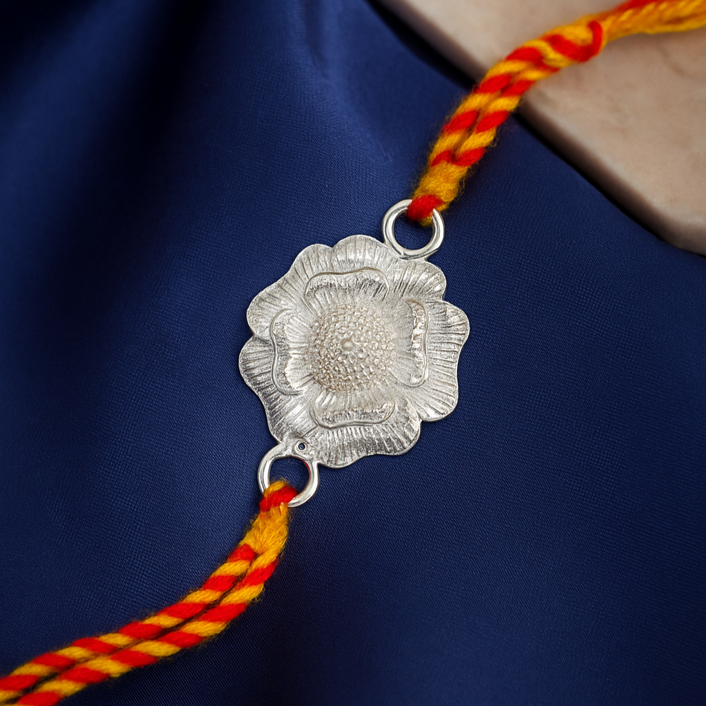 Silver floral pendant on a red